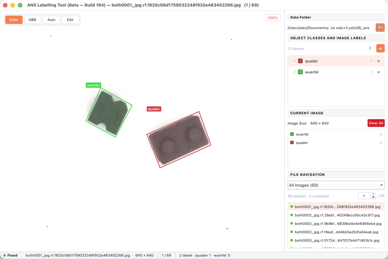 Labelling tool drawing rotated oriented bounding boxes around two angled parts.